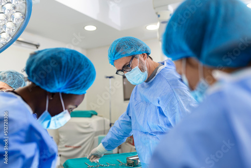 Foto Surgeon team in uniform performs an operation on a patient at a cardiac surgery clinic