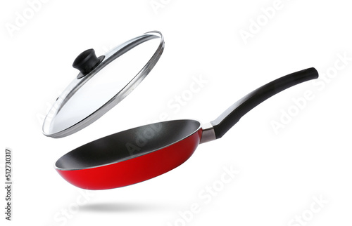New frying pan and glass lid on white background