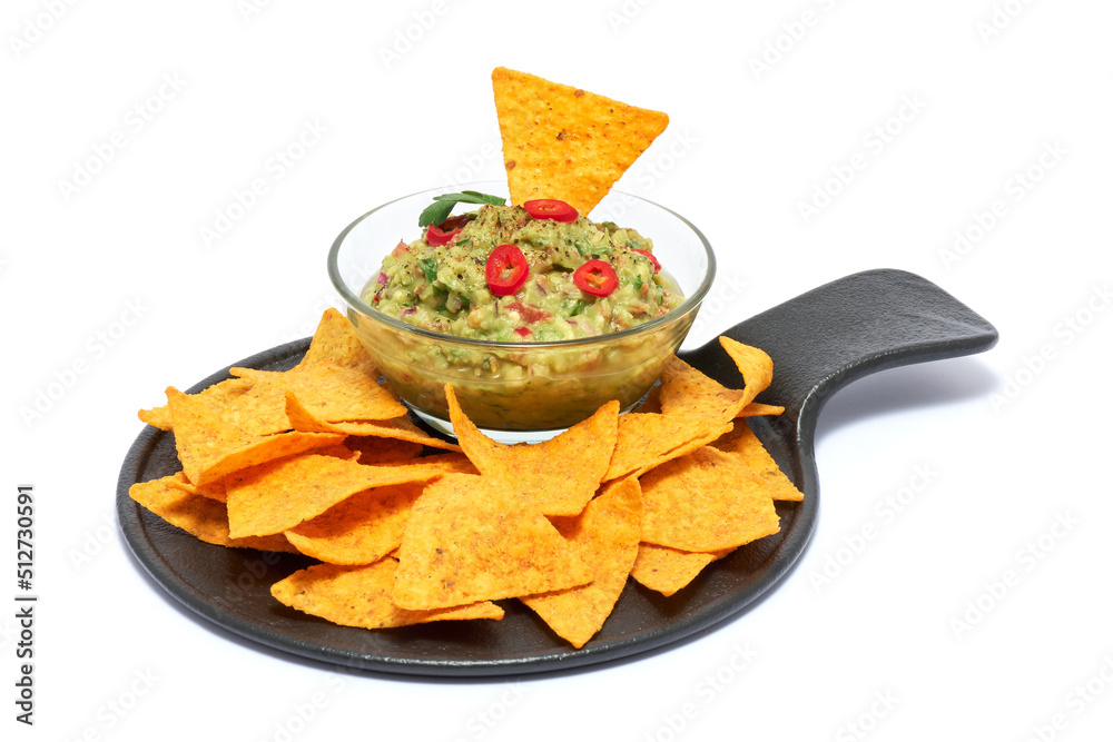Healthy vegetarian organic guacamole Mexican dip sauce served in glass bowl with nachos or tortilla chips isolated on white background Healthy vegetarian organic guacamole Mexican dip sauce served in glass bowl with nachos or tortilla chips isolated on white background