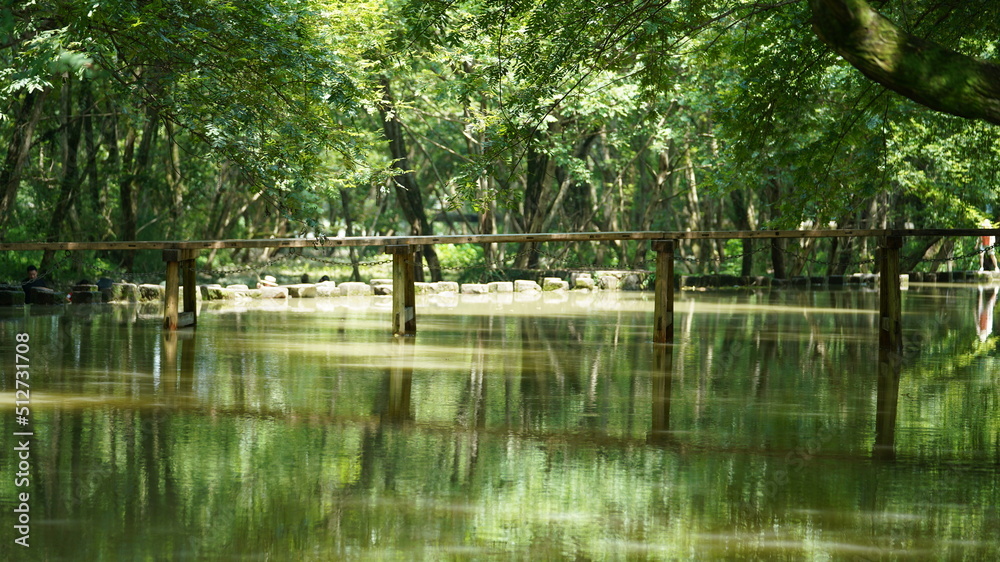 One old wooden bridge cross the river in the village of the China One old wooden bridge cross the river in the village of the China