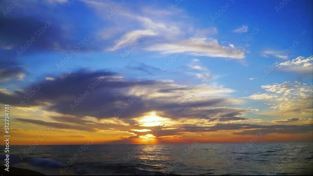 Colorful sunset on the sea. Waves shimmer in the sun. Reflection of the sun's rays in the ocean. Colorful sunset on the sea. Waves shimmer in the sun. Reflection of the sun's rays in the ocean.