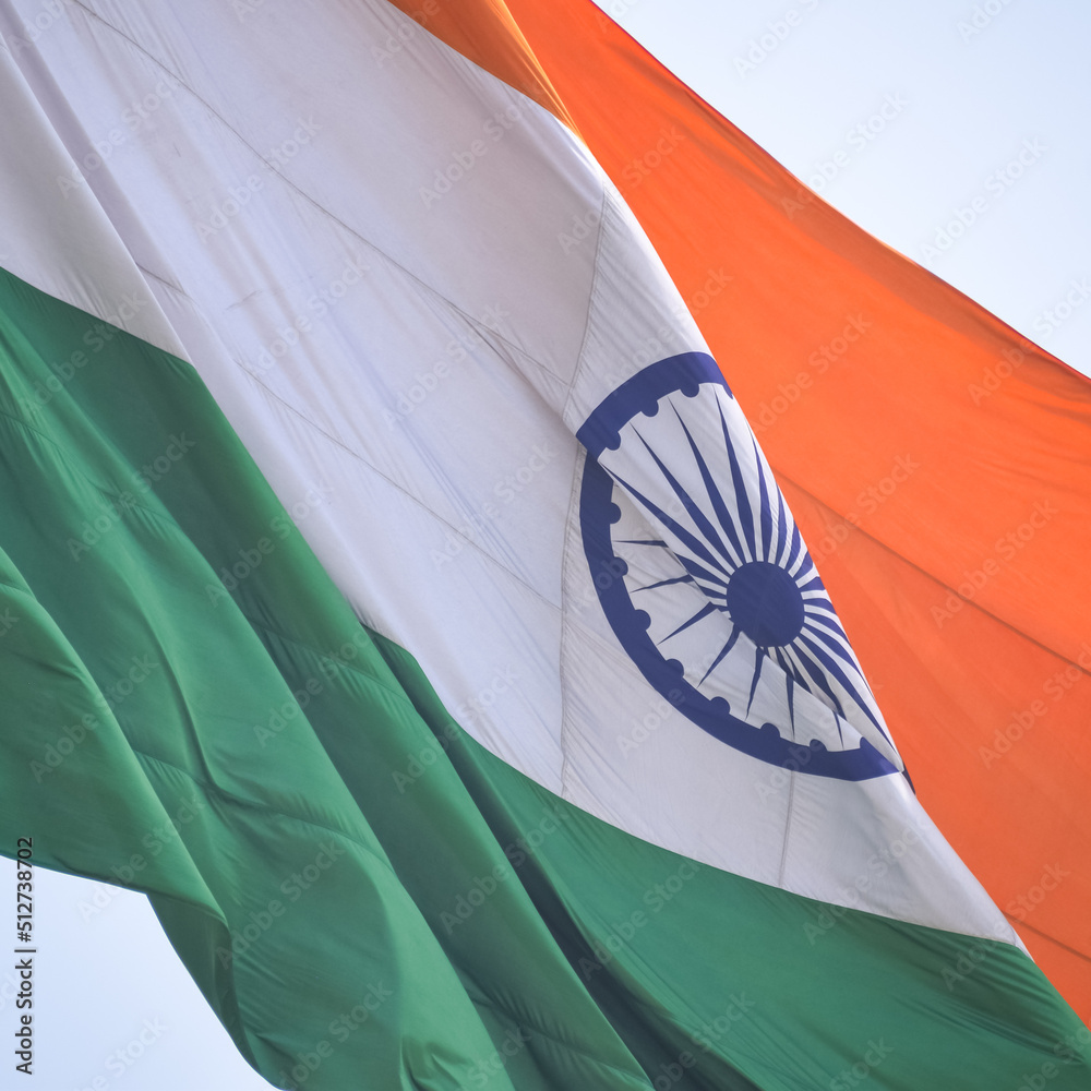 India flag flying high at Connaught Place with pride in blue sky, India