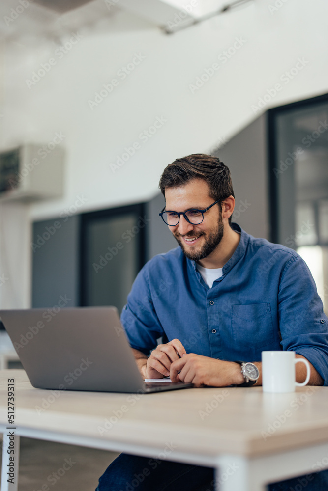 Happy businessman, making some plans while having a video call over his laptop. Happy businessman, making some plans while having a video call over his laptop.