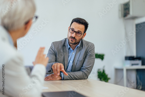 Male boss having a meeting with one female employer, suggest mistakes about the business.