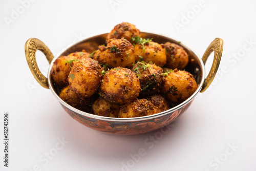 Homemade Roasted Bombay potatoes. Pan fried little baby potatoes or aloo with jeera seeds and coriander in bowl photo
