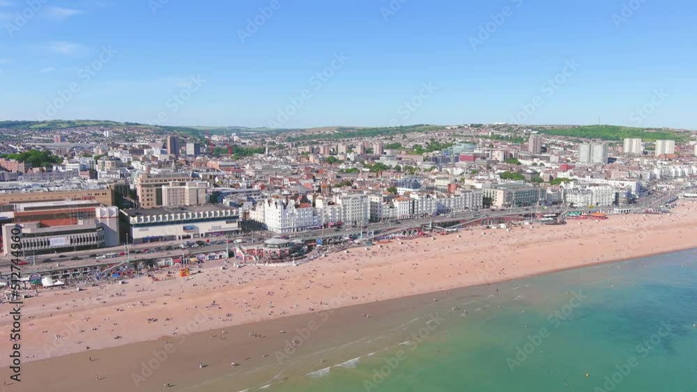 Brighton, UK: Aerial view of city in England, wide beach and blue waters of Atlantic Ocean in seaside resort in summer, sunny day with clear blue sky - landscape panorama of United Kingdom from above Brighton, UK: Aerial view of city in England, wide beach and blue waters of Atlantic Ocean in seaside resort in summer, sunny day with clear blue sky - landscape panorama of United Kingdom from above