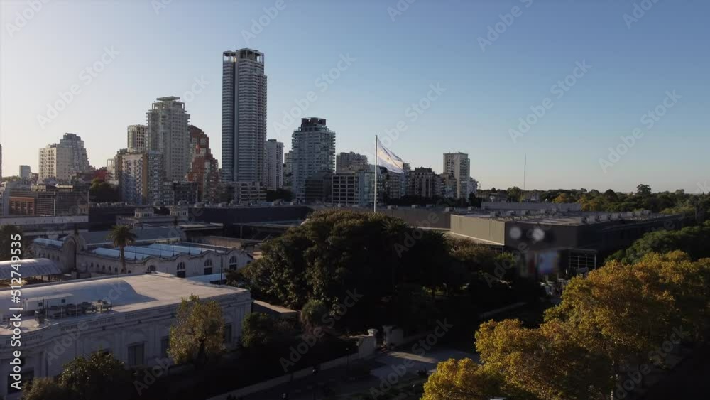 Aerial approaching shot of waving argentinian flag in front of skyline of Buenos AIres during sunset Aerial approaching shot of waving argentinian flag in front of skyline of Buenos AIres during sunset