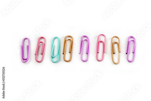 Close up of multicolored paper clips isolated on a white background. Back to school.
