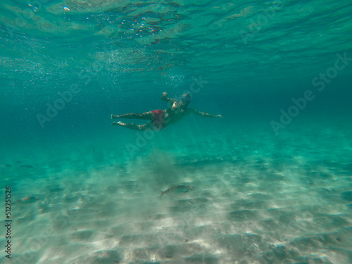underwater man snorkeling in the sea withcrystal-clear waters concept of holiday relax summer beach diver in the sea  © Enrique