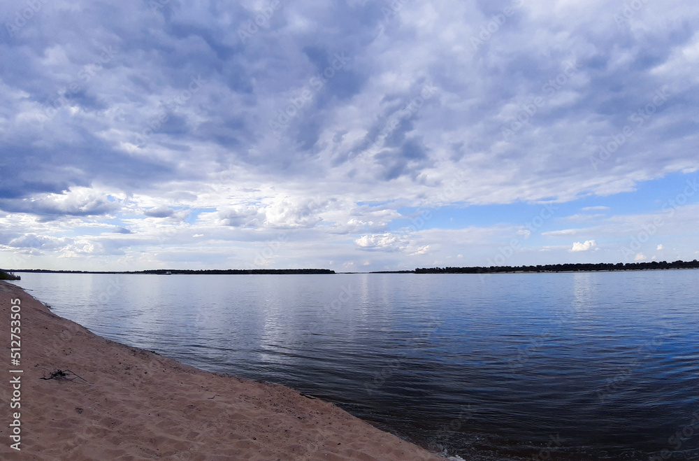 Obraz premium Reflection of the blue sky and clouds in the river. Skyline. Free beach.