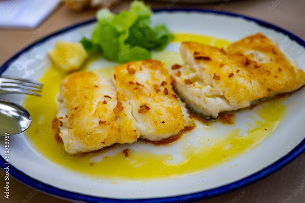 Grilled fillet of white codfish served in fish restaurant in San Sebastian, Basque Country, Spain Grilled fillet of white codfish served in fish restaurant in San Sebastian, Basque Country, Spain