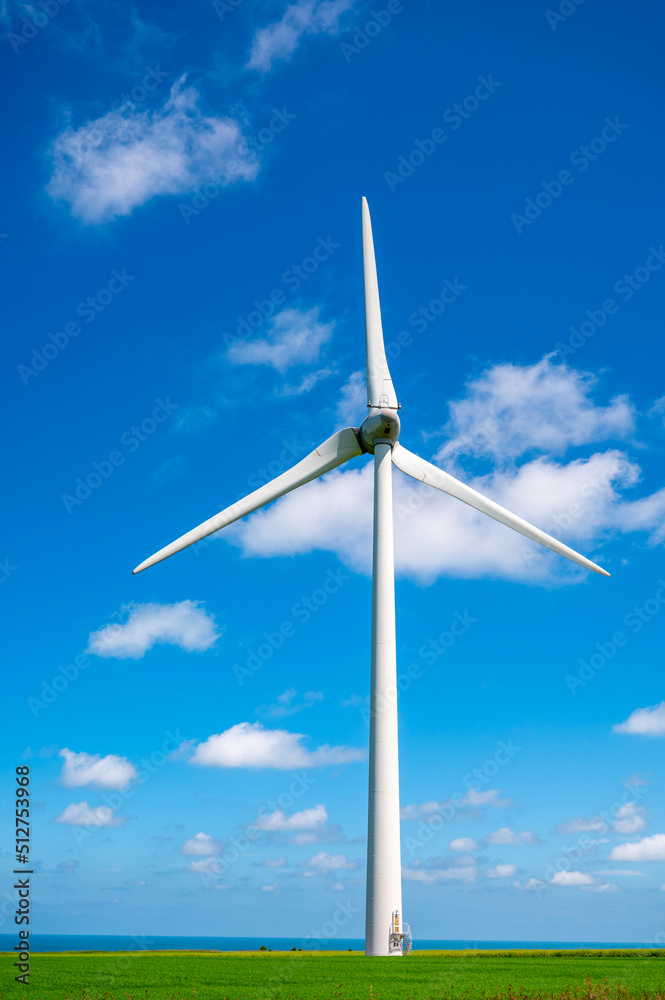 View on modern wind mills, green grain fields and blue Atlantic ocean in agricultural region Pays de Caux in Normandy, France View on modern wind mills, green grain fields and blue Atlantic ocean in agricultural region Pays de Caux in Normandy, France