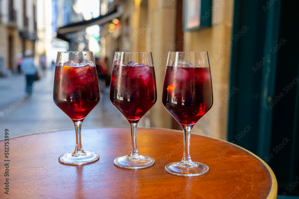 Glasses of cold sangria wine served outdoor in bar with view on old street in San Sebastian, Basque Country, Spain Glasses of cold sangria wine served outdoor in bar with view on old street in San Sebastian, Basque Country, Spain