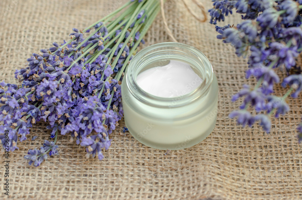 Open jar of lavender moisturizer. Jar of body cream and fresh lavender flowers Open jar of lavender moisturizer. Jar of body cream and fresh lavender flowers