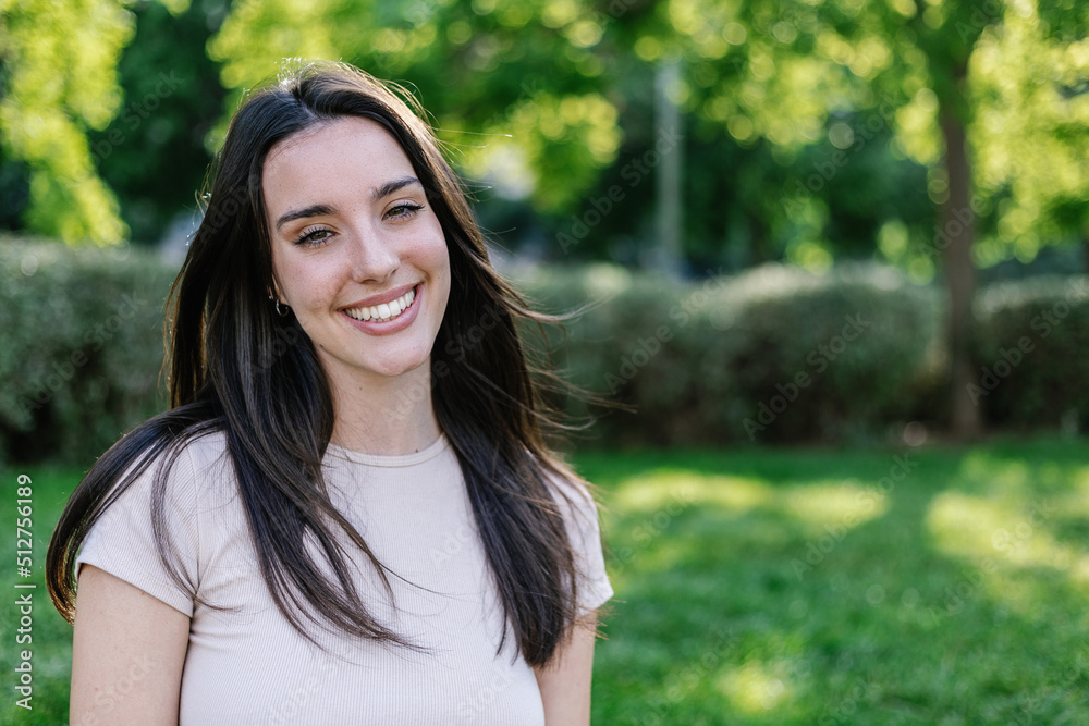 Happy pretty young adult woman posing and smiling at camera outdoors - Millennial people and youth concept Happy pretty young adult woman posing and smiling at camera outdoors - Millennial people and youth concept