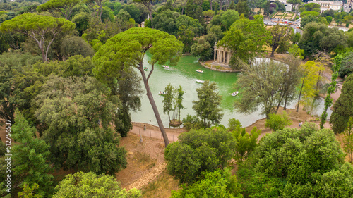 Aerial view of the small lake in Villa Borghese park. This pond is located in Rome, Italy. There are small row boats with people.