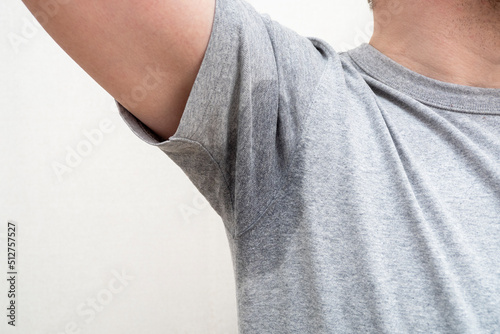 Bilde på lerret Sweaty armpit, wet underarm wet stain on grey t-shirt..