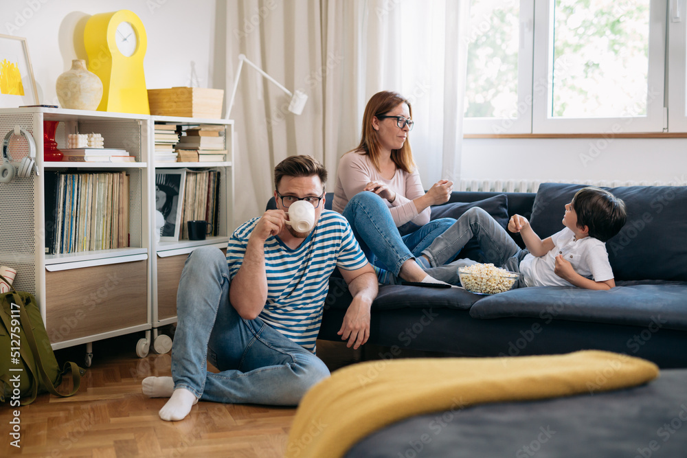 family eating popcorn and talking at home family eating popcorn and talking at home