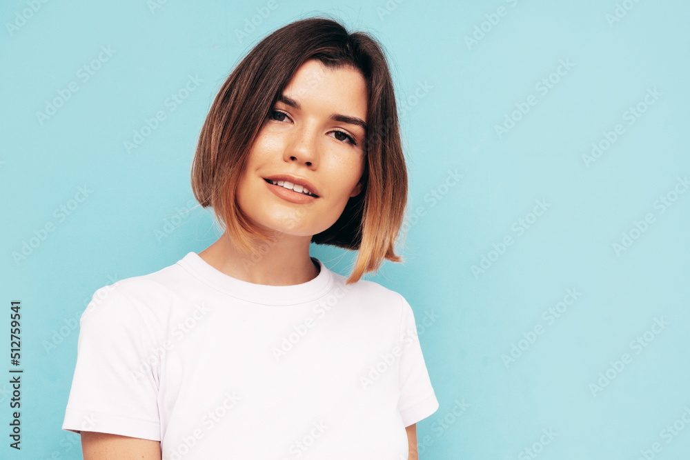 Portrait of young beautiful smiling female in trendy summer clothes. Carefree woman posing near blue wall in studio. Sexy positive model having fun indoors. Cheerful and happy. Isolated Portrait of young beautiful smiling female in trendy summer clothes. Carefree woman posing near blue wall in studio. Sexy positive model having fun indoors. Cheerful and happy. Isolated