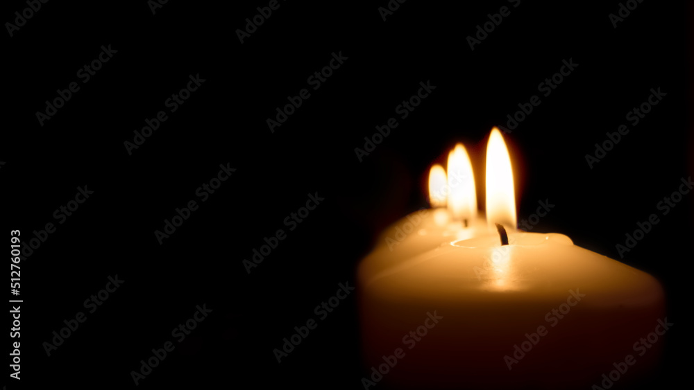 candles at night on a dark background, light and heat from the candle candles at night on a dark background, light and heat from the candle