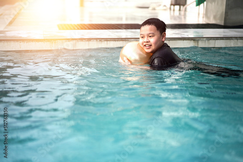 child kid smile while in swimming pool with inflate