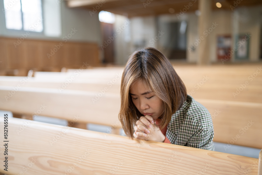 A Christian female is sitting and praying. A Christian female is sitting and praying.