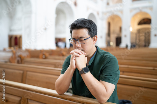 A Christian man is sitting and praying.