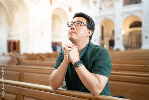 A Christian man is sitting and praying.