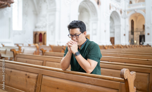 A Christian man is sitting and praying.