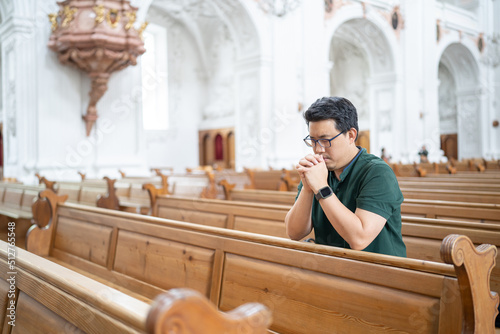 A Christian man is sitting and praying.