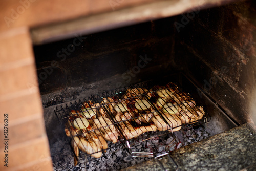 delicious grilled meat over charcoal barbecue