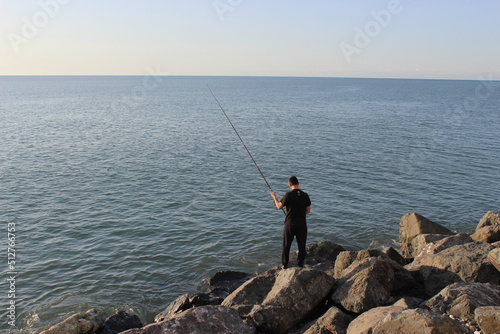 person fishing on the beach © Андрей Кузнецов