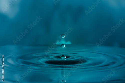 water droplets  splash  ripples  on blue light effects background.