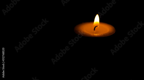Candle light isolated on dark background.