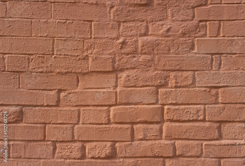 Red painted brick wall of the building