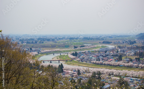 Akita,Tohoku,Japan:Panoramic view of Kakunodate town and the Hinokinaigawa River during cherry blossom festival as seen from the former site of Kakunodate Castle on the hilltop.