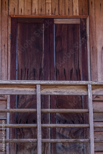 Old wooden houses along walking street(Chai Khong Road) in Chiang Khan,Loei,Thailand.Close-up the doors.