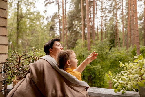 Happy grandmother and grandson enjoy time together. Positive middle age woman spending time with little, cute grandchild, having fun. 50-year-old grandma with grandkid. Multi-generational family.