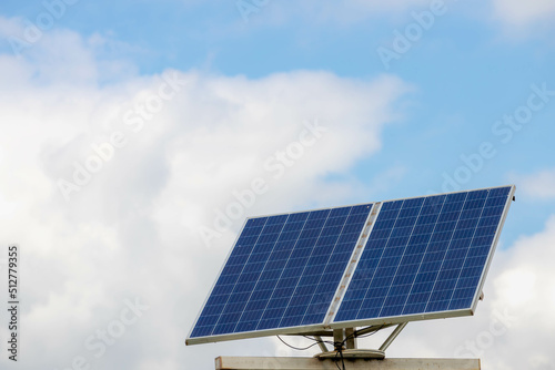Green energy concept, Solar cell panel with blue sky and white clouds, Photovoltaic cell is an electrical device that converts the energy of light directly into electricity by the photovoltaic effect.
