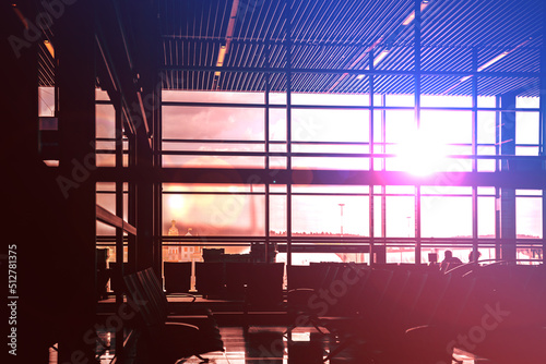 The interior of the lobby airport or office building at sunset - the light comes through the glass and spreads the room out - red, blue colors © guteksk7