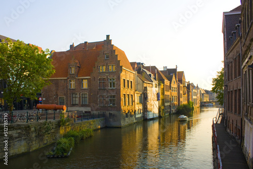 Canal with boats and beautuful architecture in Old Town of Ghent, Belgium