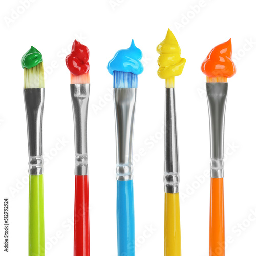 Set of different brushes with paints on white background