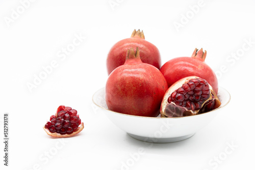 Group of pomegranate closeup isolated on white background.