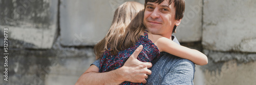man dad having quality time with their kid daughter girl nine year old hug on his arms. happy father playing with child. real life authentic day-to-day fatherhood moments. fatherly love care. banner