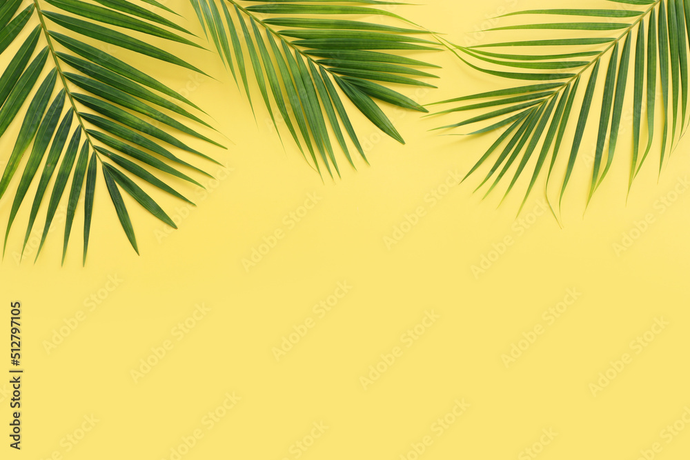 Naklejka premium Image of tropical green palm over yellow pastel background