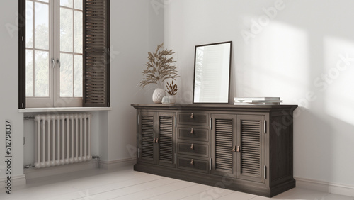Retro living room with white painted wooden floor and walls. Dark wooden rattan chest of drawer with decor. Frame mock up. Window with shutters and radiator. Vintage interior design