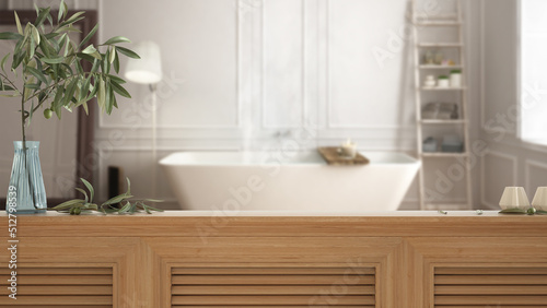 Wooden table top, cabinet, panel or shelf with shutters close up. Olive branch in vase and candles. Blurred background with classic bathroom with bathtub, interior design © ArchiVIZ