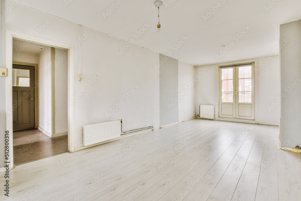 Empty room with door and radiator Empty room with door and radiator