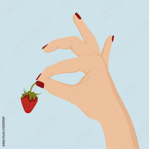 A female hand with red nail polish holds a strawberry