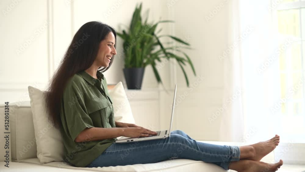 Video conference, video connect with colleagues from home. Young indian woman wearing casual shirt using laptop computer for communicating online, waving into webcam, greeting webinar participants Video conference, video connect with colleagues from home. Young indian woman wearing casual shirt using laptop computer for communicating online, waving into webcam, greeting webinar participants